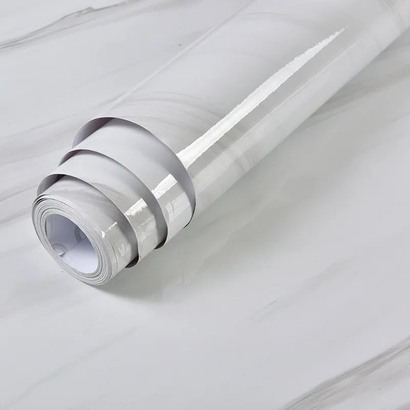 Roll of white vinyl wrap on a light gray background. Marble Peel and Stick Wallpaper