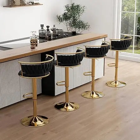 Four black and gold bar stools in a modern kitchen setting.