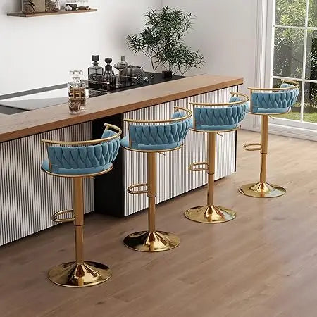 Four blue bar stools with gold bases in a kitchen setting.