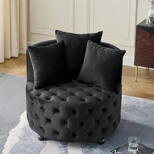 Black tufted armchair with cushions in a room setting